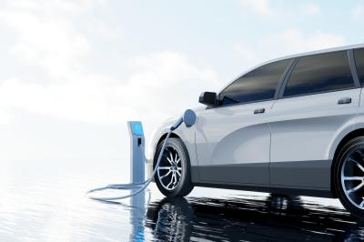 Nutzen Sie unsere Filter, um Hybrid- und Elektrofahrzeuge zu vergleichen. Elektroauto beim Laden unter freiem Himmel.